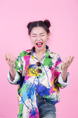 Fashion girl dress up with hand gestures on a pink background.