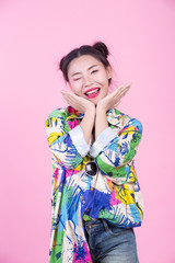 Fashion girl dress up with hand gestures on a pink background.