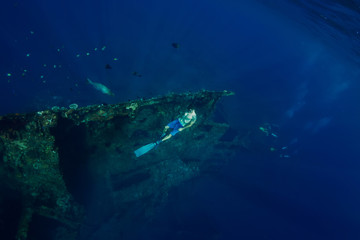 Fototapeta na wymiar Freediver man dive underwater at shipwreck in Bali. Freediving in ocean