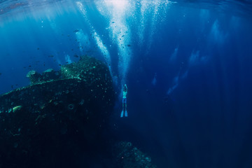 Freediver man dive underwater at shipwreck in Bali. Freediving in ocean