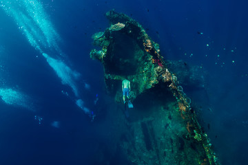 Freediver man dive underwater at shipwreck in Bali. Freediving in ocean