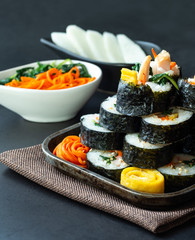 Set of kimbub or sushi roll in steel plate ready to serve in korean style menu with chopstick.
