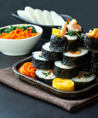 Set of kimbub or sushi roll in steel plate ready to serve in korean style menu with chopstick.
