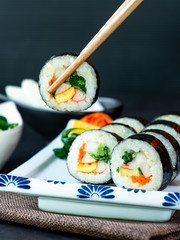 Set of kimbub or sushi roll in white ceramic plate ready to serve in korean style menu.
