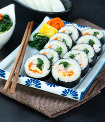 Set of kimbub or sushi roll in white ceramic plate ready to serve in korean style menu.