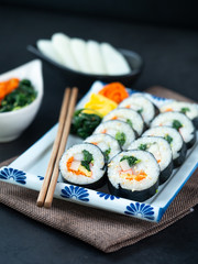 Set of kimbub or sushi roll in white ceramic plate ready to serve in korean style menu.