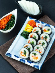 Set of kimbub or sushi roll in white ceramic plate ready to serve in korean style menu.