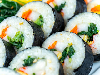 Set of kimbub or sushi roll in ceramic white  plate ready to serve in korean style menu.