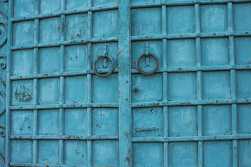 blue vintage metal door with round knobs