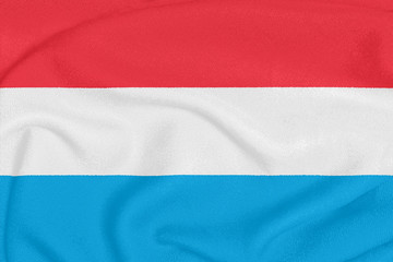 Flag of Luxembourg on textured fabric. Patriotic symbol