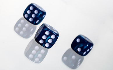 Three blue casino dice with white slanted background