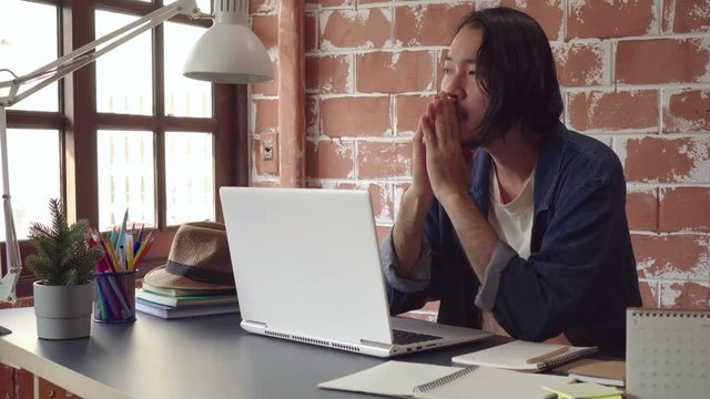 Asian man thinking of new idea and get inspiration while working at office