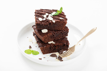 Homemade brownie with dark chocolate isolated on white background.