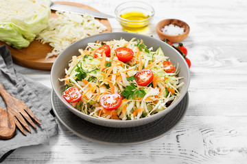 Fresh Cabbage salad with carrots and greens.