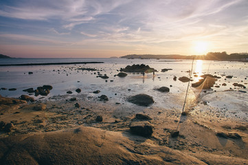 Beautiful sunset landscape with sea beach and fishing net.