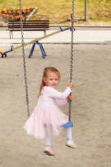 little girl on swing