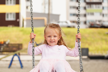 little girl on a swing