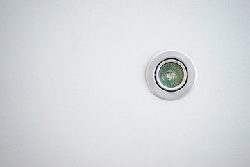 Small lamp spot on white ceiling.