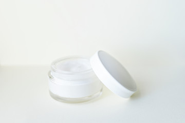 Cosmetic cream container on white background from top view . copy space . skin body face care concept