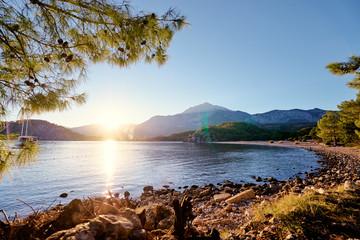 Sunset on the Meditterranean sea. Landscape with beach and mountains.