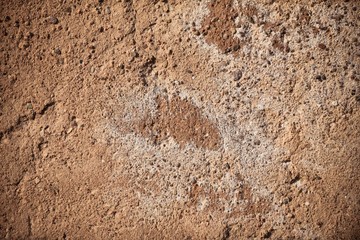 A fragment of a concrete wall of small pebbles, similar to sand