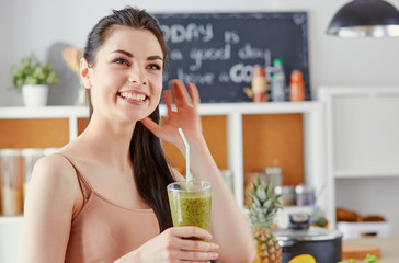 a young girl drinks a cocktail on a kitchen