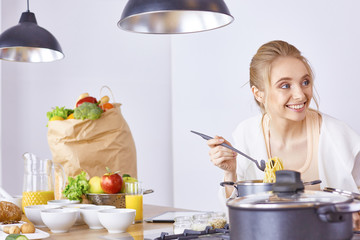 Young Woman Cooking in the kitchen. Healthy Food