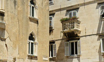 Stone houses with windows and balcony in the street of old town, Diocletian's Palace beautiful architecture, sunny day, Split, Dalmatia, Croatia