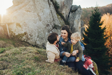 Happy family: mother father and child in mountains. 