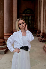 Fashion look's woman. Young woman modern portrait. Young woman dressed in white skirt and shirt...