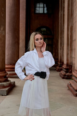 Fashion look's woman. Young woman modern portrait. Young woman dressed in white skirt and shirt...