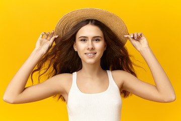 Attractive fashionable good looking young Caucasian female with wavy loose hair hold on to her...