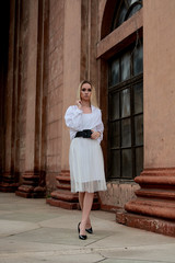 Fashion look's woman. Young woman modern portrait. Young woman dressed in white skirt and shirt...