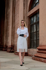 Fashion look's woman. Young woman modern portrait. Young woman dressed in white skirt and shirt...