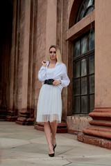 Fashion look's woman. Young woman modern portrait. Young woman dressed in white skirt and shirt...