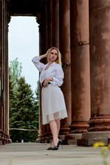 Fashion look's woman. Young woman modern portrait. Young woman dressed in white skirt and shirt...
