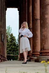 Fashion look's woman. Young woman modern portrait. Young woman dressed in white skirt and shirt...