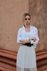 Fashion look's woman. Young woman modern portrait. Young woman dressed in white skirt and shirt...