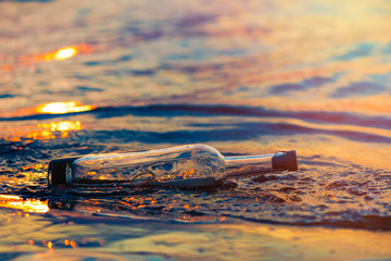 Message in a corked bottle on the shore, hope of salvation
