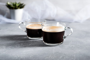 Two Cups of coffee on grey background