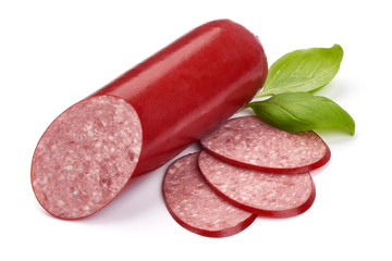 Dry salami sausage stick with basil leaves, close-up, isolated on white background