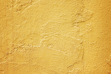 Texture gold yellow cement wall in rough cracked patterns abstract for background