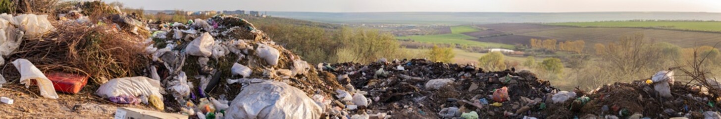 Fototapeta premium Environmental disaster. Clogging the outskirts of the city. Garbage heaps are an element of the modern European landscape.