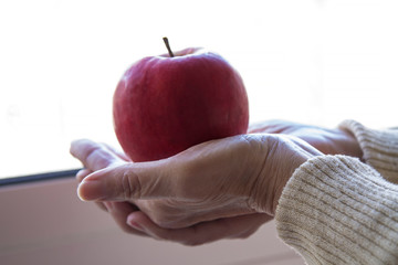 woman holding apple in hands, diet and health concept