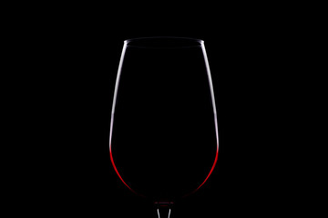 Red wine glass silhouette on black background
