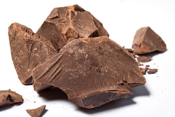 Cacao paste or mass (Theobroma cacao). Broken chocolate pieces ingredients for making chocolate.
