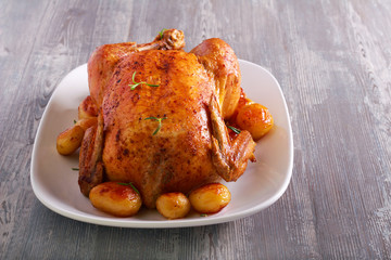 Roast whole chicken with potatoes