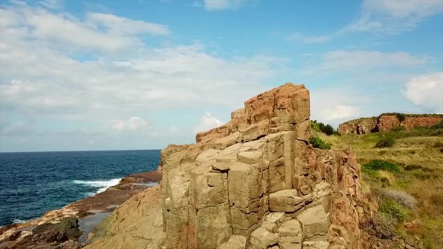 Natural rock formations of basalt columns on the Australian coastline of an ancient Bombo quarry