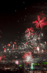 New year's eve fireworks over a dark town.