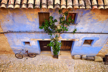 Bicycle on a blue facade. Mediterranean style